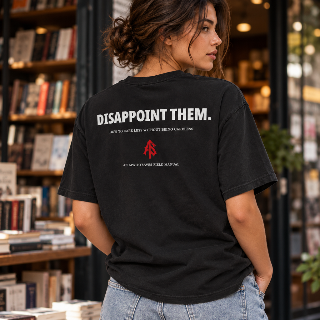 Lifestyle concept of woman wearing black DISAPPOINT THEM. statement T-shirt near bookstore