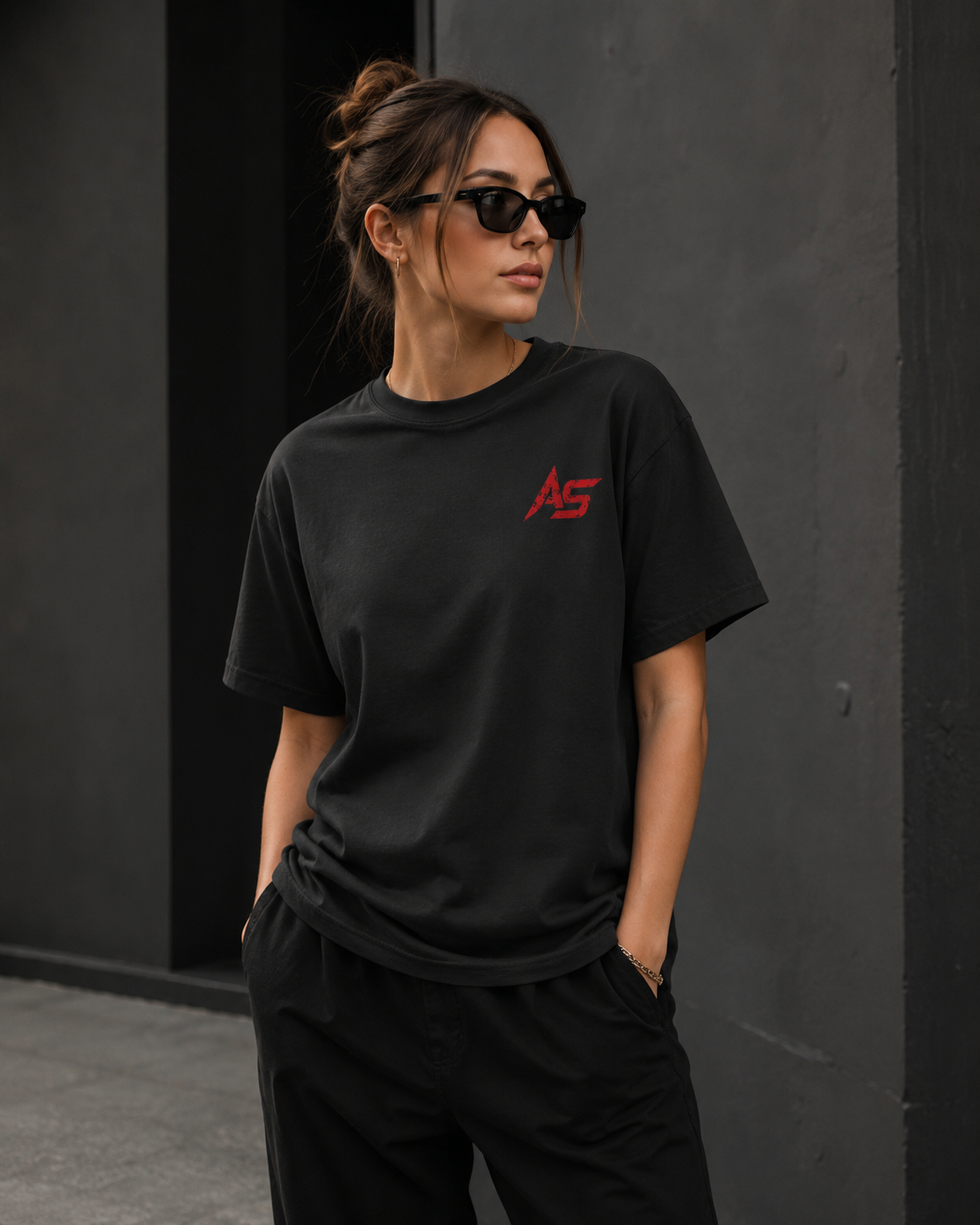 Female model wearing oversized black ApathySaves t-shirt with red AS chest logo